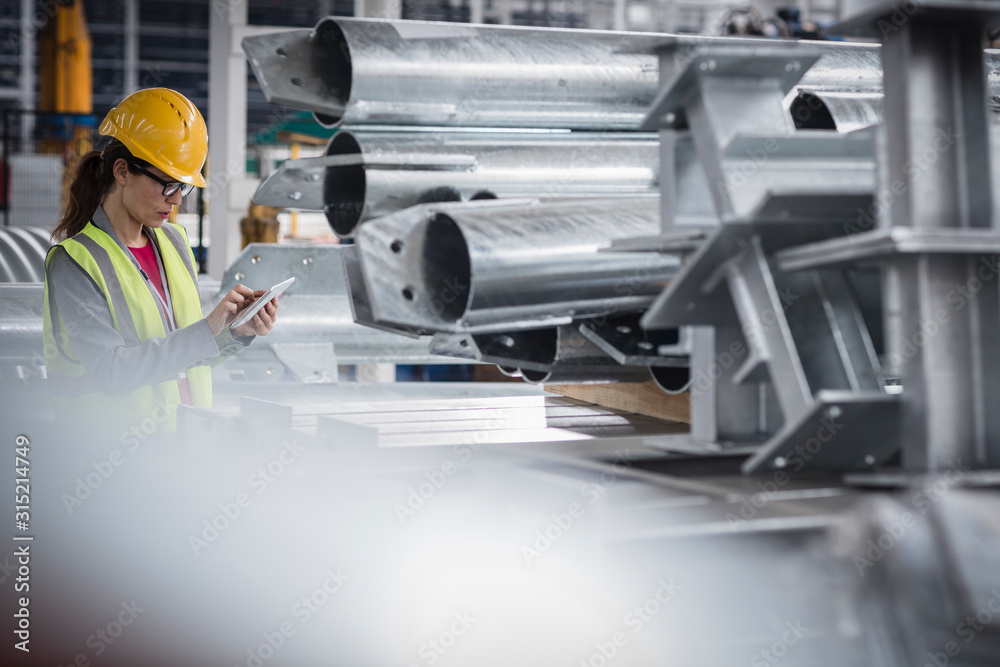 Female supervisor with digital tablet working in steel factory Female supervisor with digital tablet working in steel factory