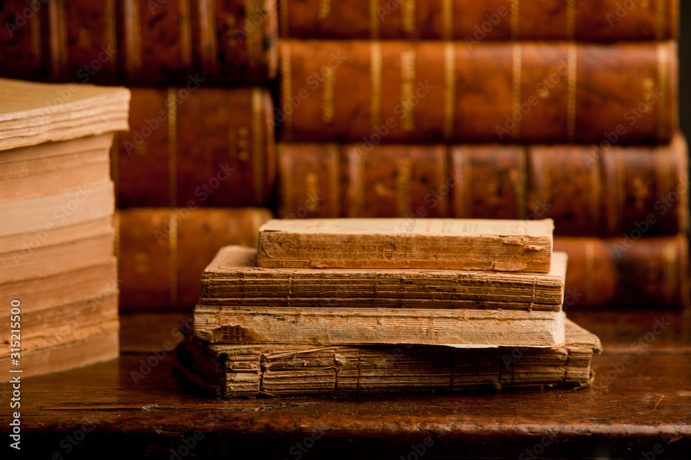old books on old wooden shelf, with books in the background old books on old wooden shelf, with books in the background