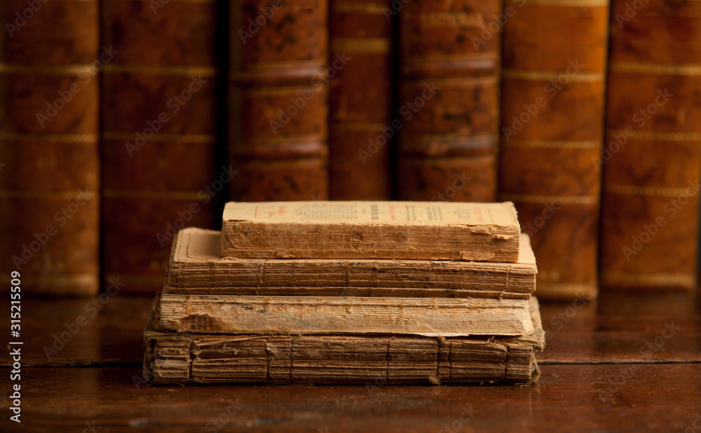old books on old wooden shelf, with books in the background old books on old wooden shelf, with books in the background