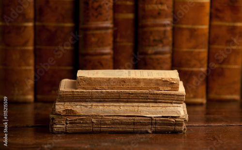 old books on old wooden shelf, with books in the background