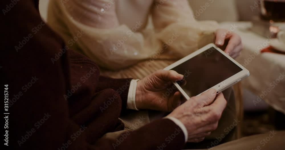 Granddaughter And Grandfather Discussing Over Digital Tablet At Home Granddaughter And Grandfather Discussing Over Digital Tablet At Home