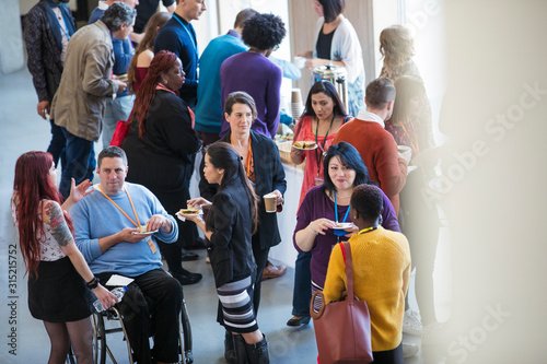Business people networking, talking at conference