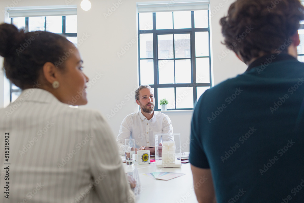 © Sam Edwards/Caia Image - Focused male architect listening in conference room meeting