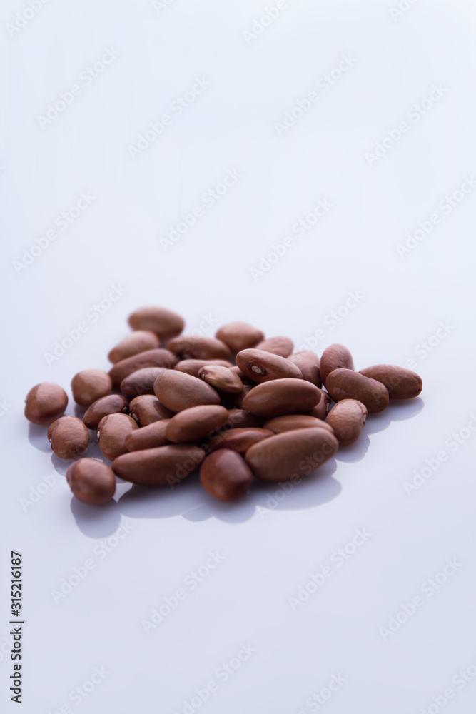 Heap of brown beans. White isolated background. Heap of brown beans. White isolated background.