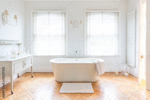 White, luxury home showcase bathroom soaking tub parquet hardwood floor photo
