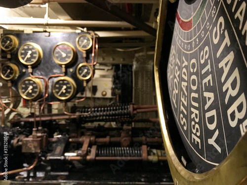 Ancient and historic mechanical control panels with lights and analogue displays in machine room of old ocean cruise ship liner photo