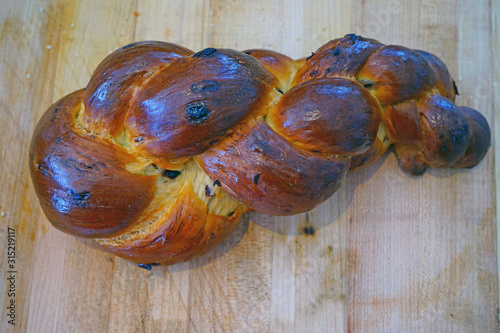 A braided challah brioche bread with raisins photo