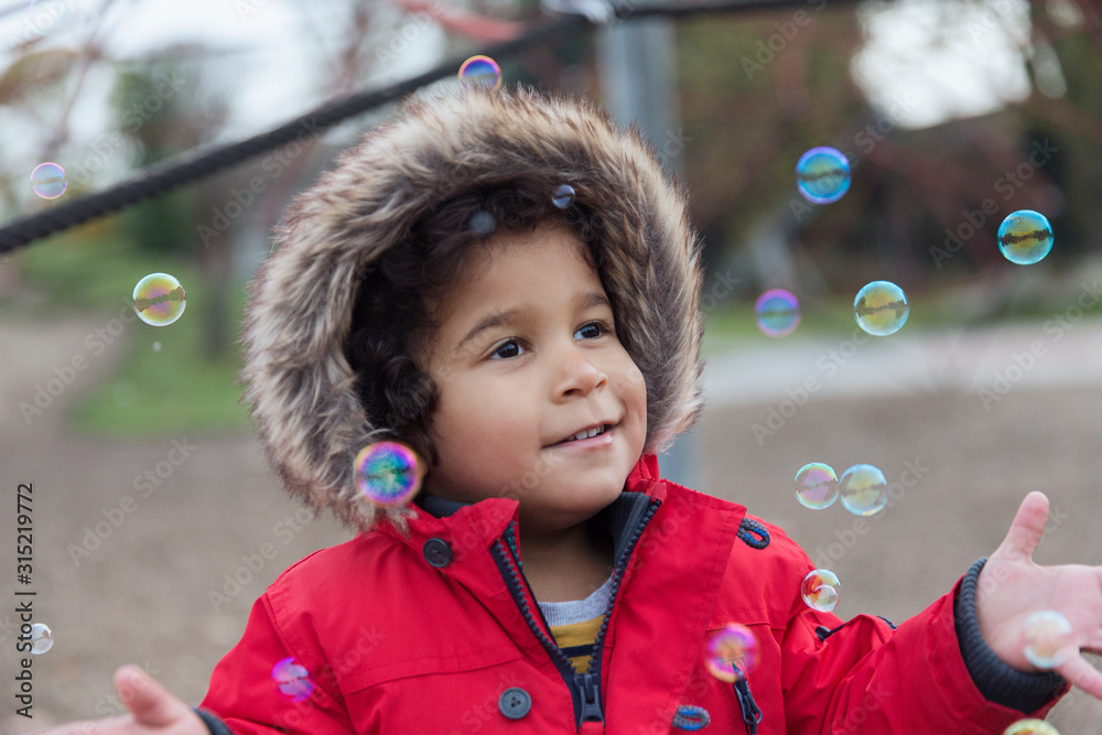 Playful toddler boy playing with bubbles Playful toddler boy playing with bubbles