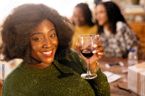Portrait smiling, confident young woman drinking red wine