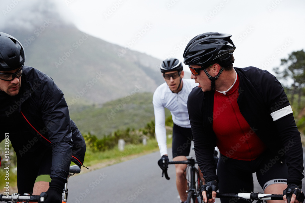 Male cyclist friends cycling Male cyclist friends cycling