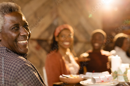 Portrait smiling multi-generation family enjoying Christmas dinner
