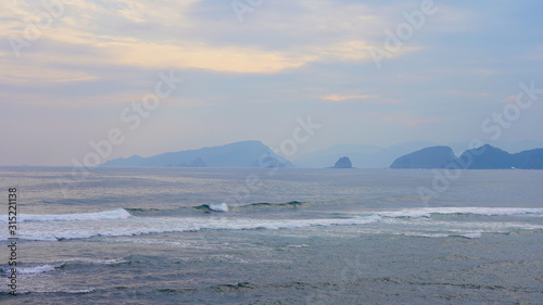 cloudy sky over the pacific ocean. Bright sunset sky over the surf waves in the ocean. rays of the sun through the clouds on the surface of the sea, reflection
