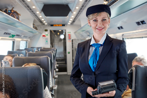 Portrait confident female attendant on passenger train