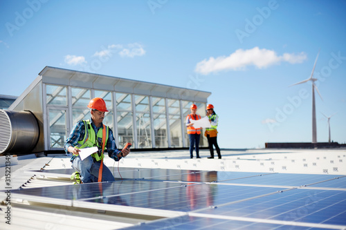 Wallpaper Mural Engineer testing solar panels at sunny power plant Torontodigital.ca