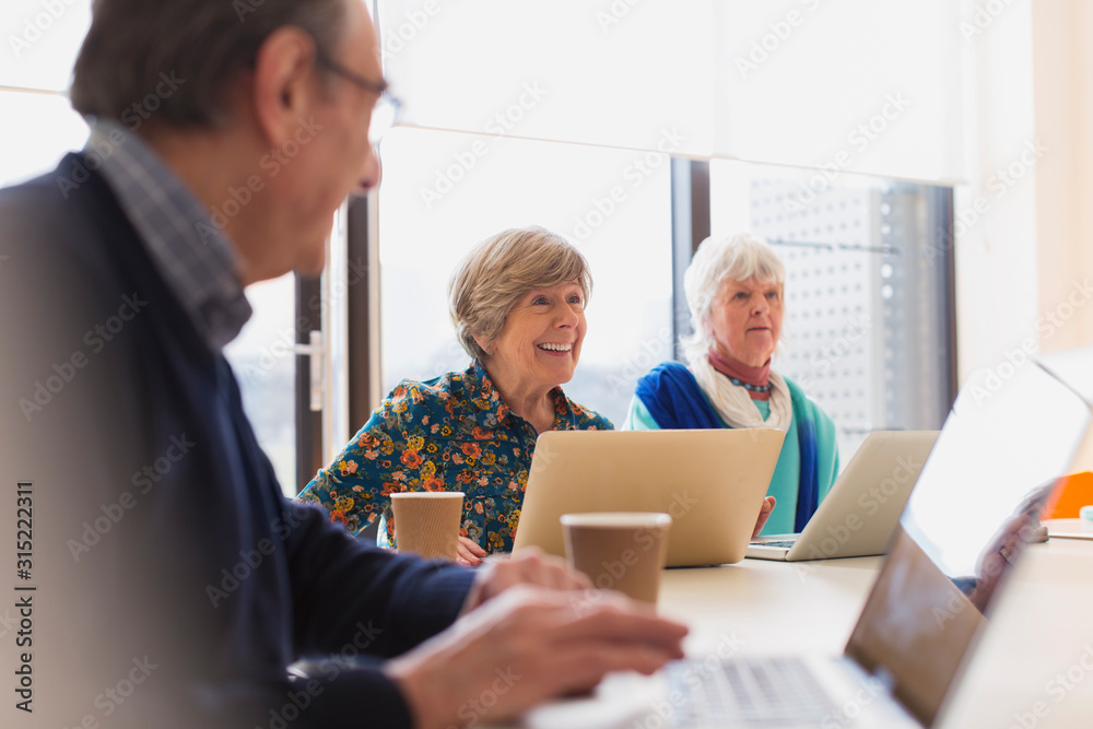 Senior businesswomen using laptops in conference room meeting Senior businesswomen using laptops in conference room meeting