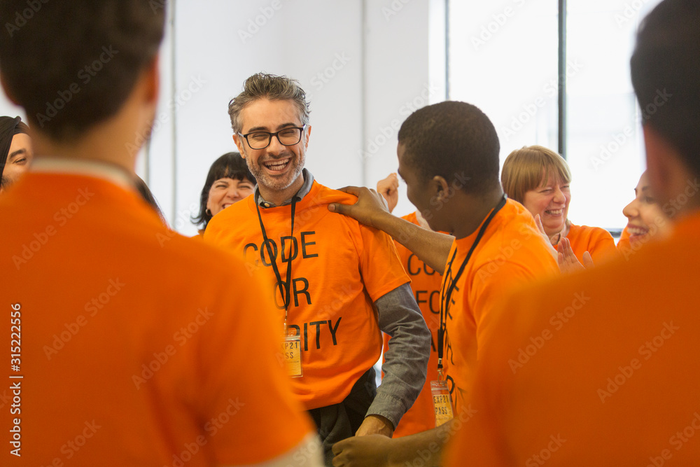 Happy hackers coding for charity at hackathon Happy hackers coding for charity at hackathon