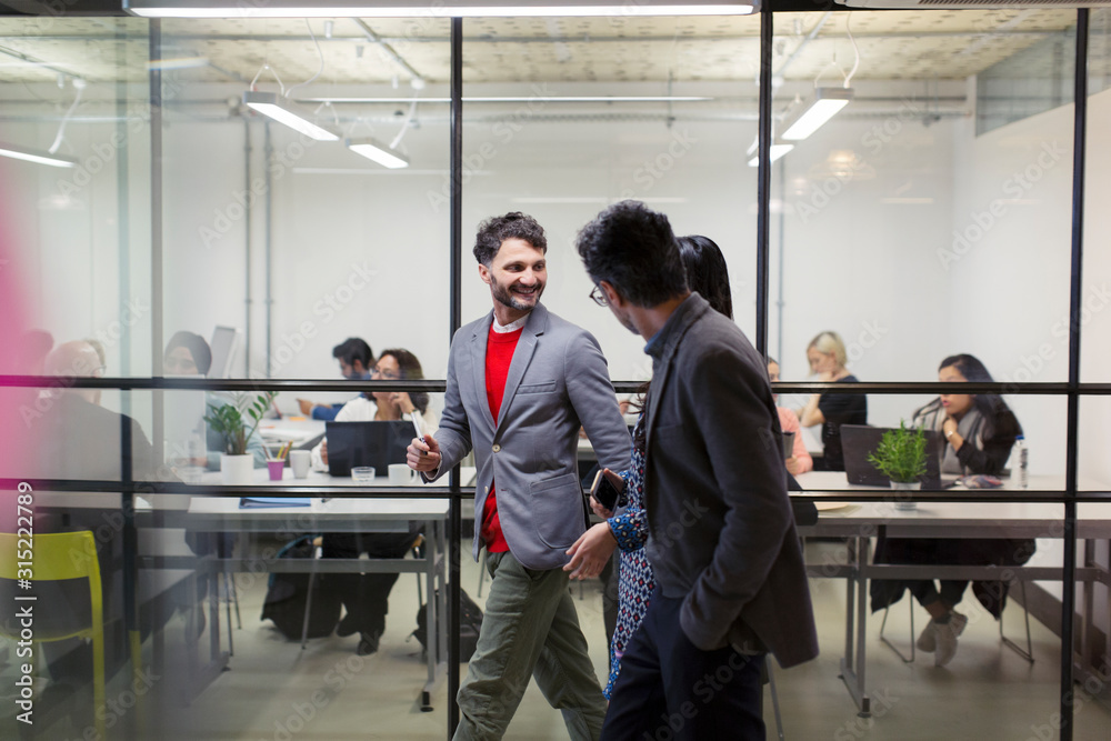 Business people walking and talking in office Business people walking and talking in office