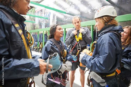 Friends preparing zip line equipment photo