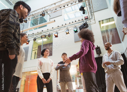 Teenagers talking in dance class studio