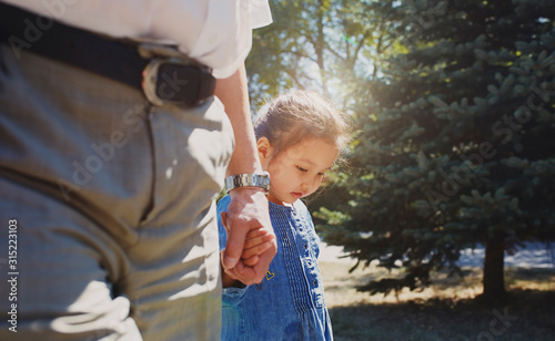 Grandfather holding hands with innocent granddaughter photo