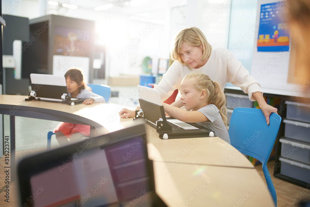Teacher and student using laptop Teacher and student using laptop
