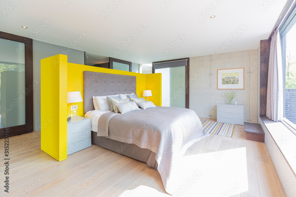 Modern bedroom with yellow and gray headboard Modern bedroom with yellow and gray headboard