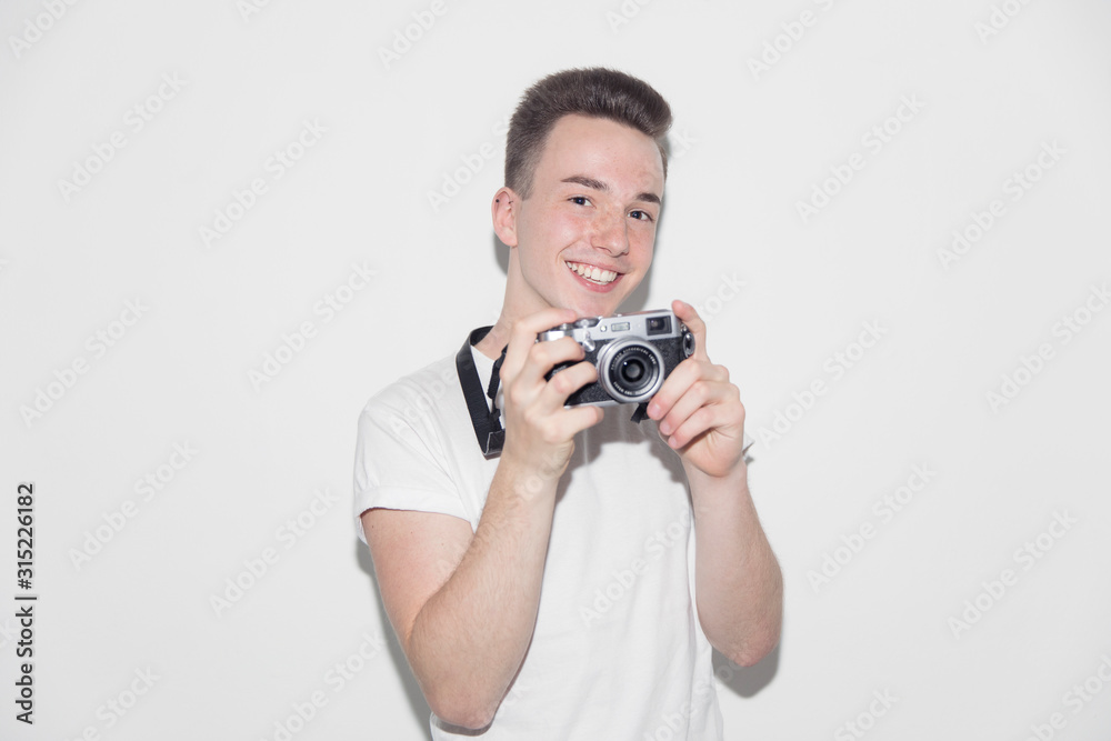 Portrait smiling, confident teenage boy with retro camera Portrait smiling, confident teenage boy with retro camera