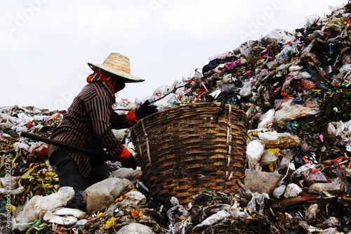 Wallpaper Mural Poor people find or searching garbage for sell to reuse and recycle in landfill. This life and living. Torontodigital.ca