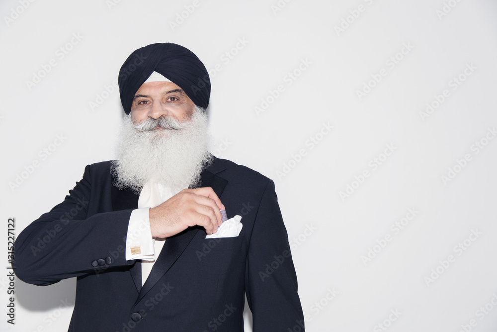 Portrait confident senior man with white beard wearing turban