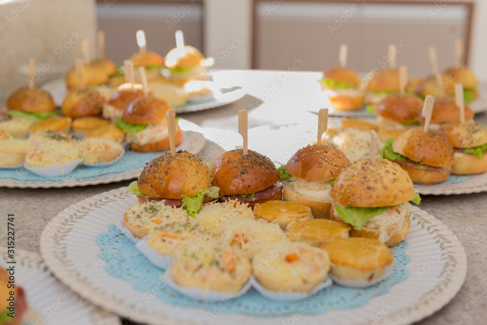 Trays with sandwiches and salted. Popular kids party foods in Brazil.