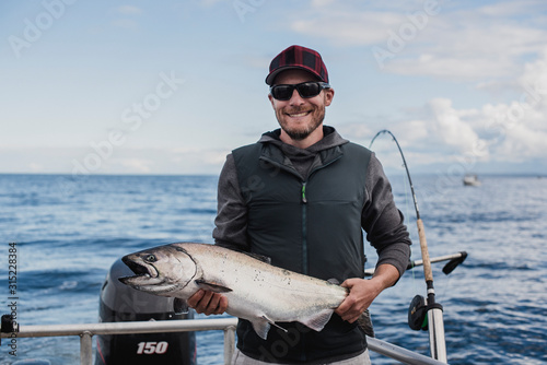 Portrait confident male fisherman catching fish photo