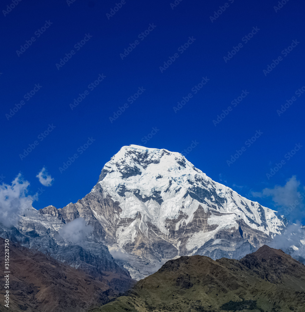 Top of the hill, covered with snow and white clouds