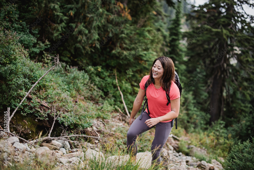 Happy young woman hiking in woods Happy young woman hiking in woods