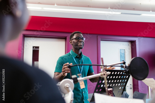 Confident male conductor in music recording studio photo