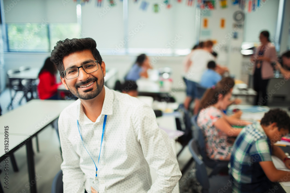 Portrait smiling, confident male teacher in classroom Portrait smiling, confident male teacher in classroom
