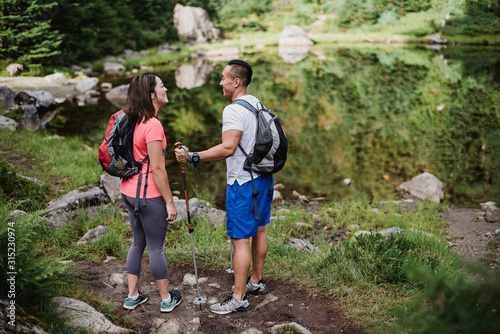 Couple hiking at lake in woods photo