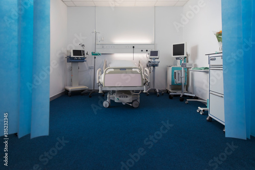 Vacant hospital room with bed and medical equipment