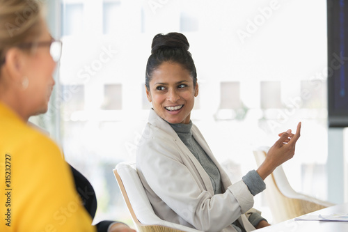 Smiling businesswoman talking in meeting photo