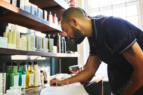 Male barbershop owner doing paperwork