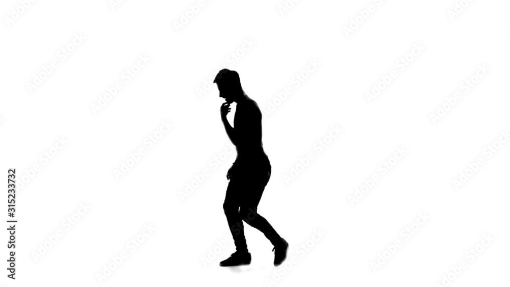 Silhouette of Man is dancing breakdance on the white background in simple grey t-shirt and grey jeans. Slow motion. Silhouette of Man is dancing breakdance on the white background in simple grey t-shirt and grey jeans. Slow motion.
