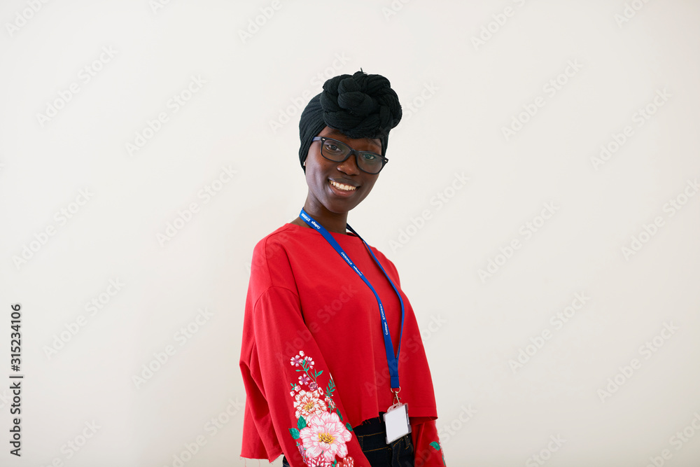Portrait confident young woman wearing dhuku headscarf Portrait confident young woman wearing dhuku headscarf