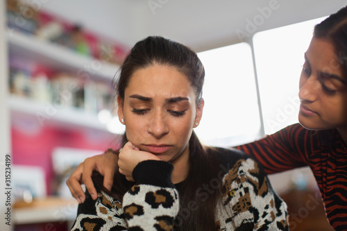 Teenage girl comforting upset friend