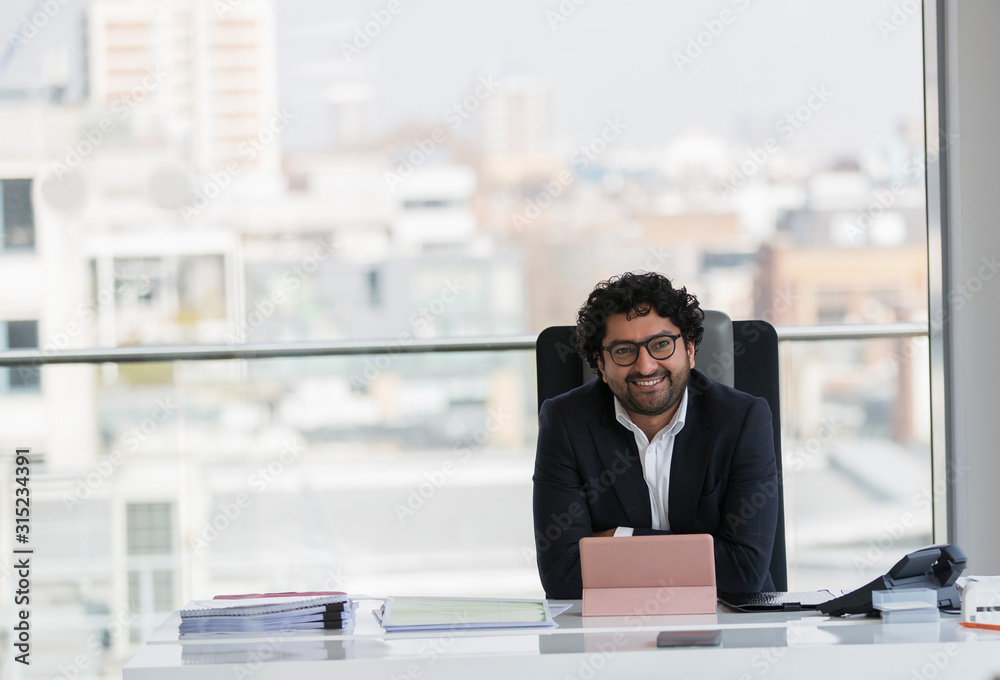 Portrait smiling, confident businessman working in office Portrait smiling, confident businessman working in office
