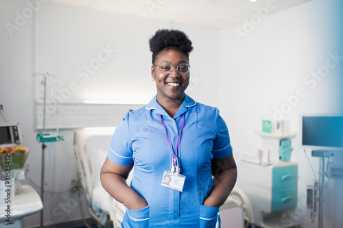 Portrait confident, smiling female nurse in hospital room photo