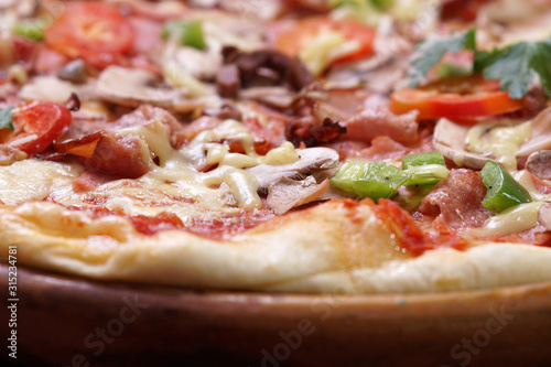Close up of fresh baked pizza with prosciutto and bacon