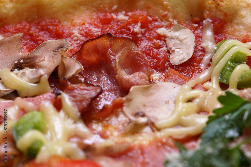 Close up of fresh baked pizza with prosciutto and bacon Close up of fresh baked pizza with prosciutto and bacon