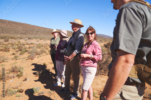 Happy woman enjoying safari with friends South Africa photo