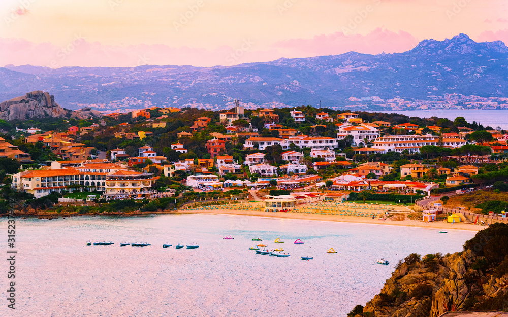 Fototapeta premium Landscape and scenery of Baja Sardinia luxury resort in at sunset evening, Sardegna island in Italy in summer. Olbia province. Villas And Mediterranean sea. Mixed media.