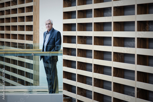 Wallpaper Mural Portrait serious businessman standing on walkway in modern office Torontodigital.ca