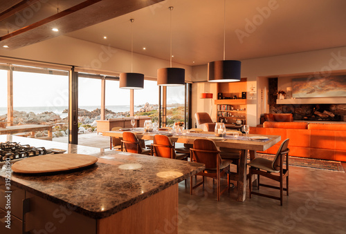 Sunny home showcase interior overlooking ocean photo
